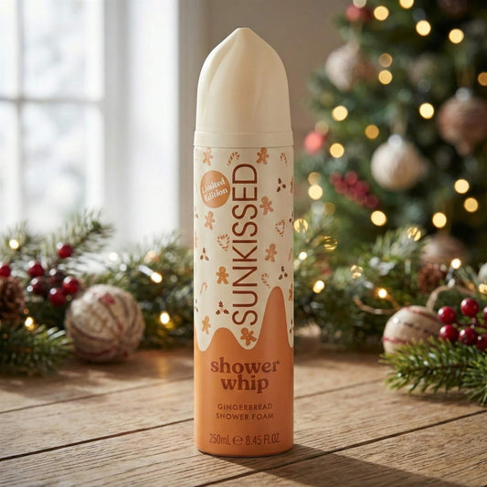Limited Edition Sunkissed Gingerbread Shower Whip 250ml shower foam displayed in a festive holiday setting with a Christmas tree
