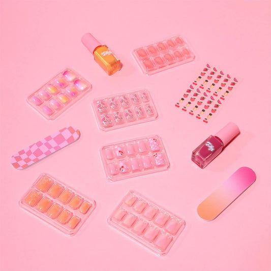 Individual components of Tilly Ultimate Nail Set with pink and orange press on nails nail stickers and polish on a pink background
