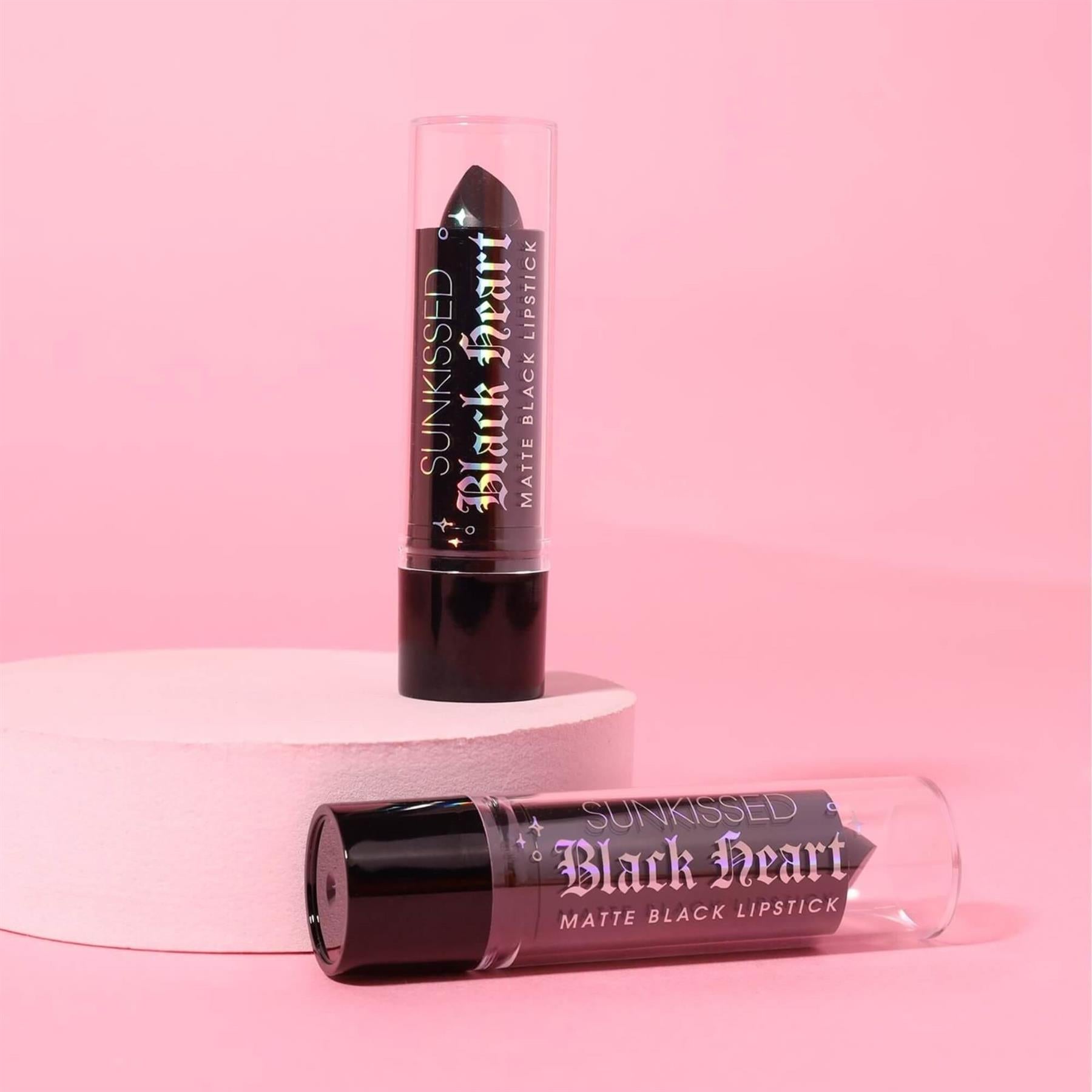 Sunkissed Black Heart matte black lipstick duo on pink podium for alternative beauty aesthetic