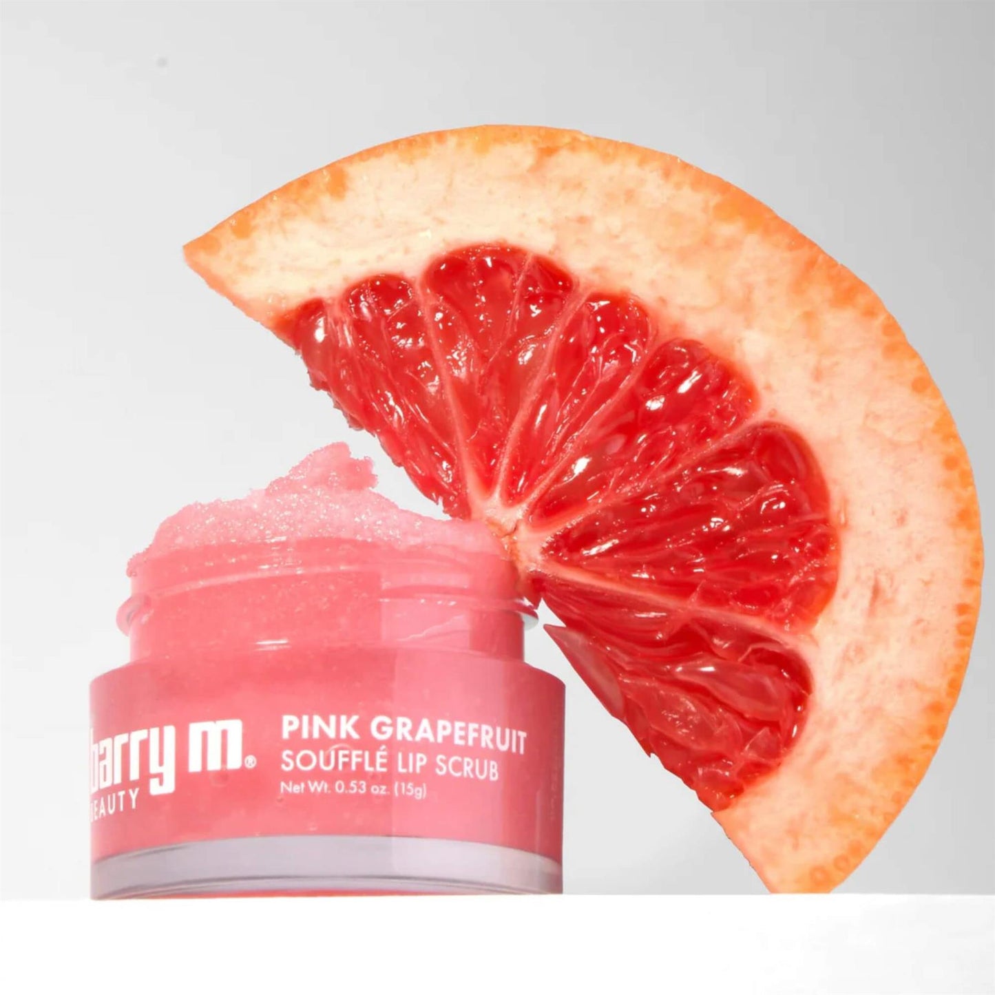 Barry M Pink Grapefruit Soufflé Lip Scrub 15g jar with coral pink sugar scrub texture and a fresh grapefruit slice