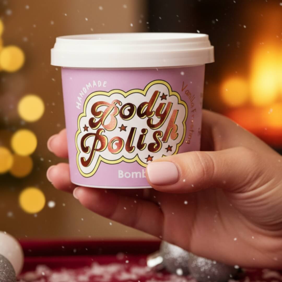 Hand holding a pink 'Body Polish' container with a festive background