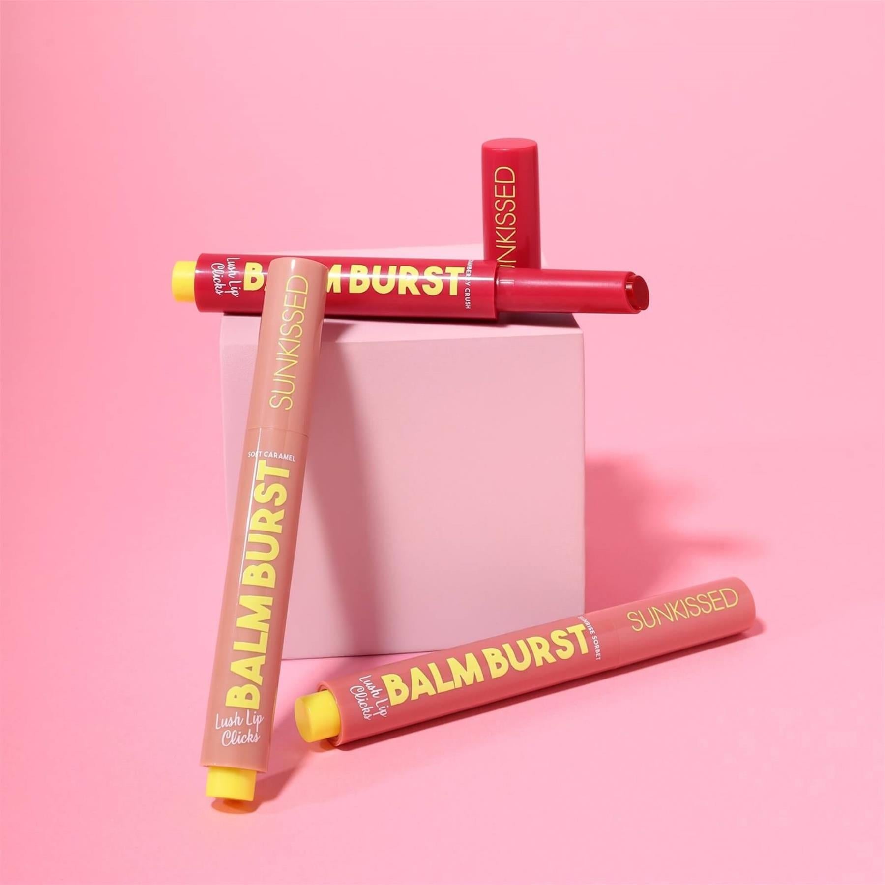 Sunkissed Balm Burst Lush Lip Clicks trio with open Cranberry Crush pen showing glossy red balm texture