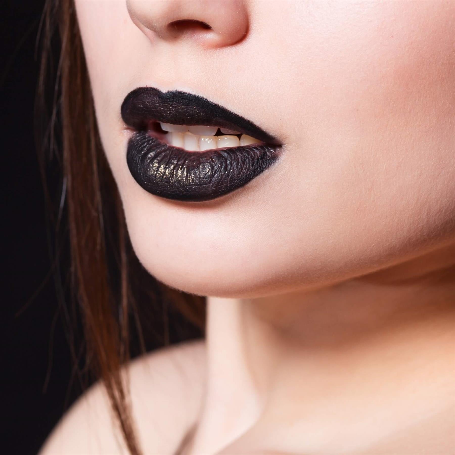 Close-up of a model wearing Sunkissed Black Heart matte black lipstick with a high-pigment finish