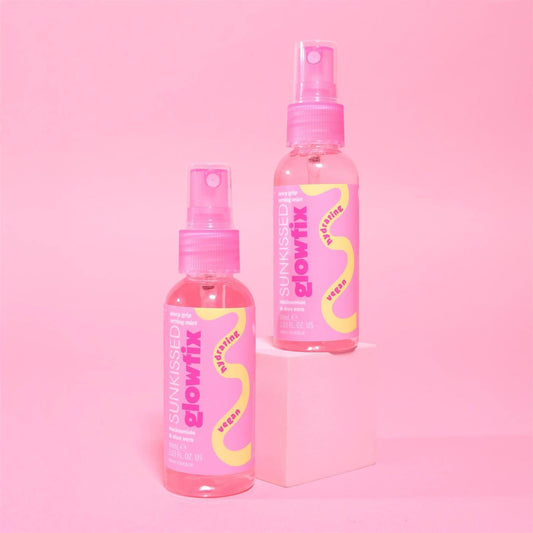 Sunkissed GlowFix Dewy Grip Setting Mist duo standing bottles showing pink hydrating liquid