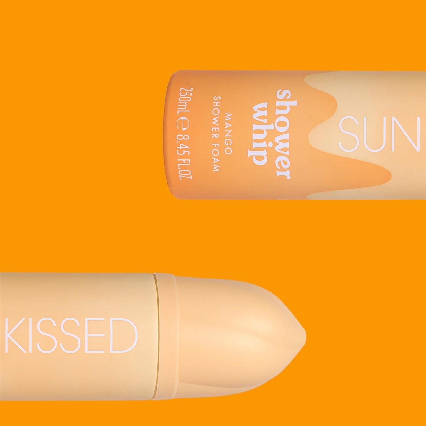 Two Sunkissed Mango Shower Whip bottles displayed horizontally against a vibrant orange background