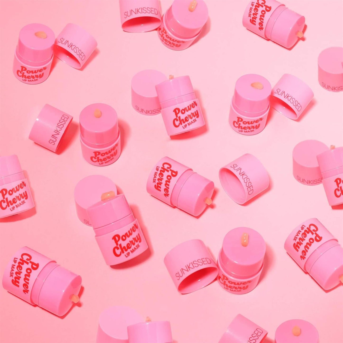 Sunkissed Power Cherry Lip Mask flat lay pattern with multiple pink tubs scattered