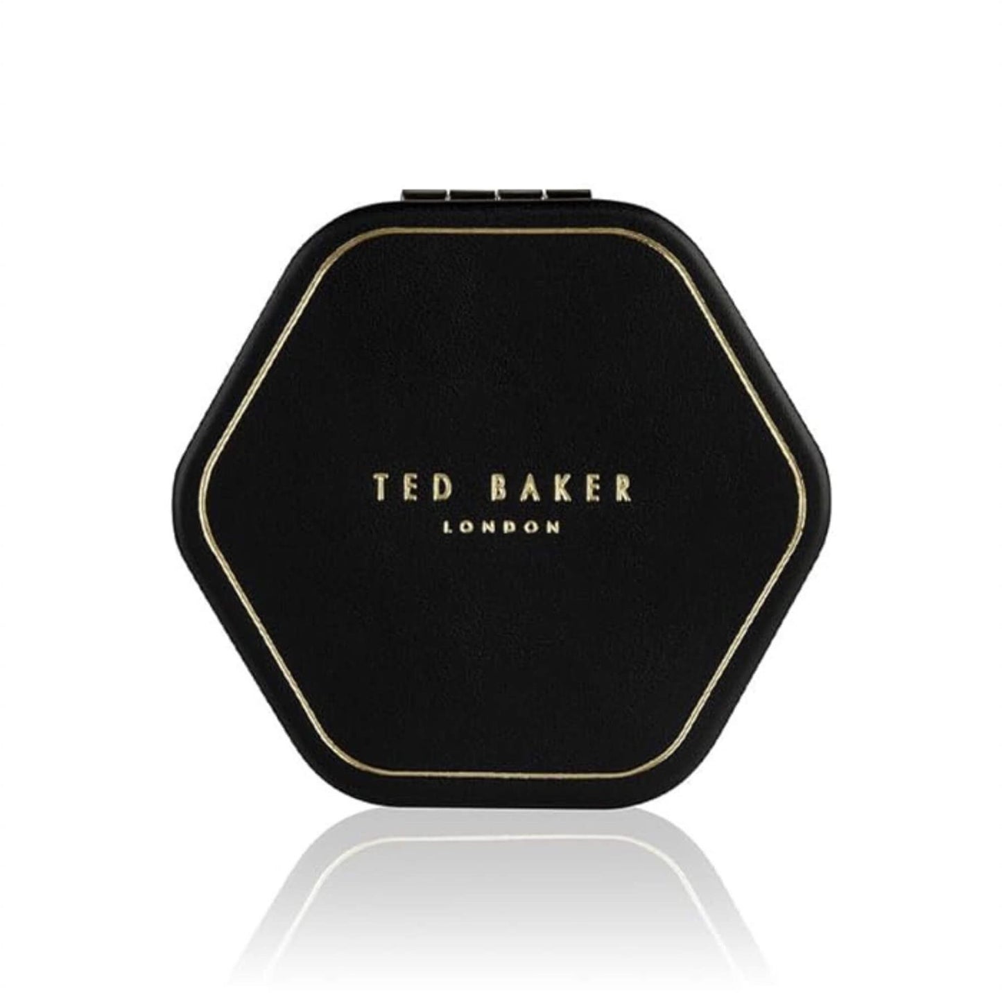 Closed Ted Baker black hexagonal compact mirror with gold embossed logo on a white background