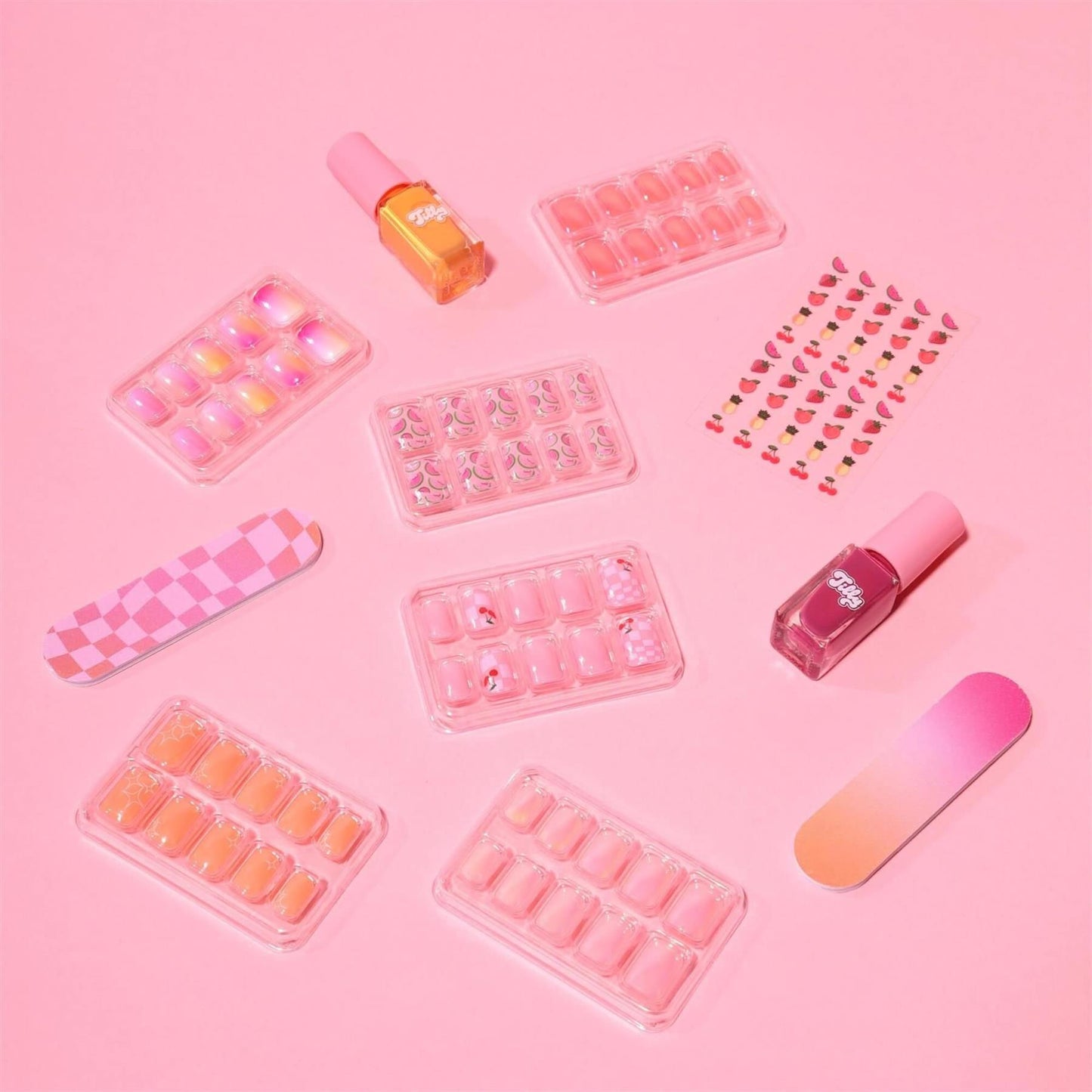 Individual components of Tilly Ultimate Nail Set with pink and orange press on nails nail stickers and polish on a pink background